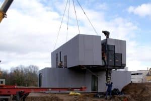 Workers assembling prefabricated modules on-site in Turkey, demonstrating the efficient construction process.